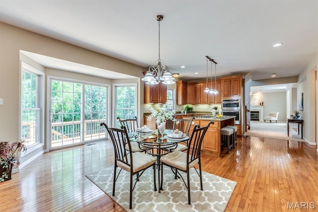 1515 Dietrich Glen Dr, Ballwin, MO 63021 - dining area with light wood finished floors, healthy amount of natural light, a chandelier, and recessed lighting