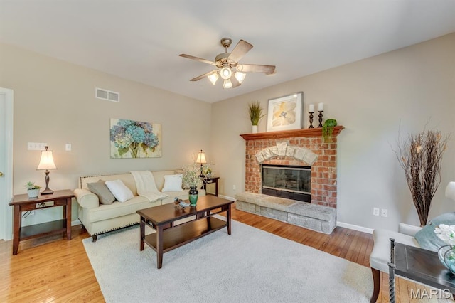 1515 Dietrich Glen Dr, Ballwin, MO 63021 - living room with a ceiling fan, wood finished floors, and a brick fireplace