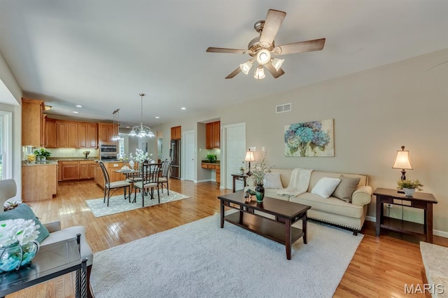 1515 Dietrich Glen Dr, Ballwin, MO 63021 - living area featuring recessed lighting, ceiling fan, light wood-style floors, and a chandelier