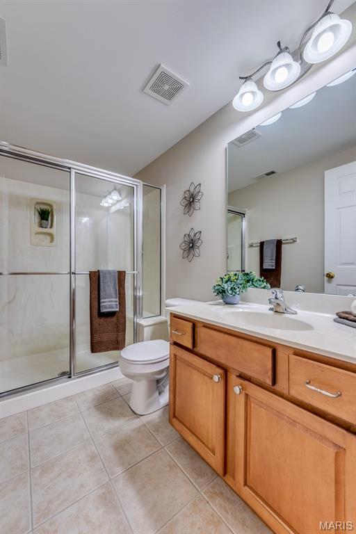 1515 Dietrich Glen Dr, Ballwin, MO 63021 - full bath featuring vanity, tile patterned floors, and a stall shower