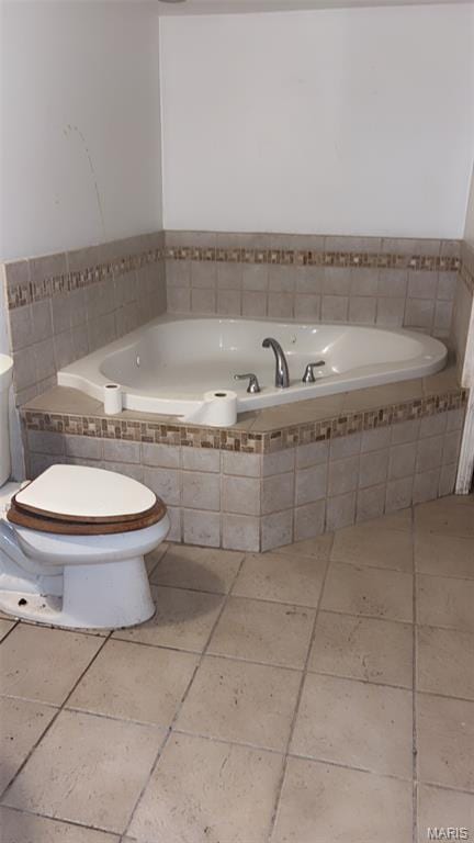 1178 Riverview Blvd, Saint Louis, MO 63147 - bathroom with tiled tub and tile patterned flooring