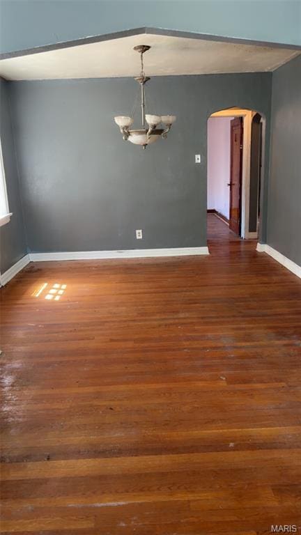 1178 Riverview Blvd, Saint Louis, MO 63147 - spare room featuring arched walkways, wood finished floors, and a chandelier