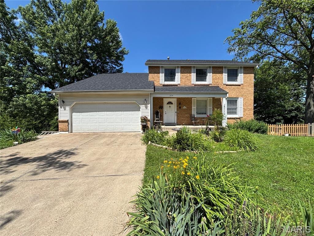 3714 Pinon Pine Ct, Oakville Township, MO 63129 - traditional-style home with brick siding, driveway, an attached garage, and a porch
