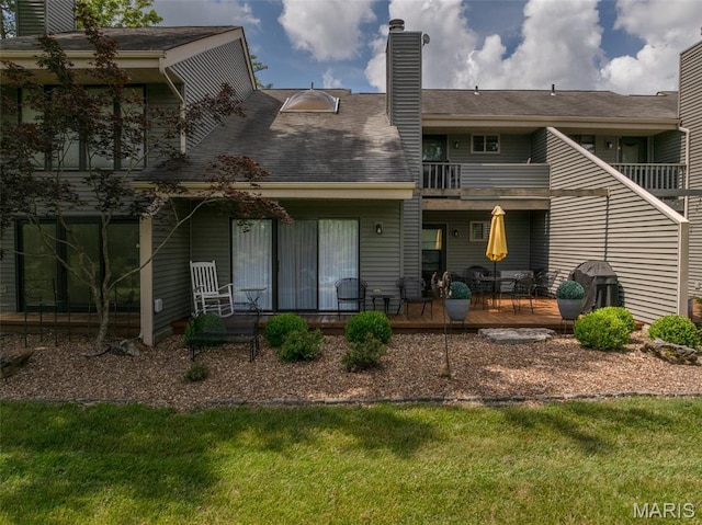 15 Lionshead Ridge Dr Unit 15, Innsbrook, MO 63390 - rear view of property featuring a balcony, a chimney, and a lawn