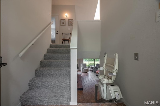 15 Lionshead Ridge Dr Unit 15, Innsbrook, MO 63390 - staircase with a high ceiling and baseboards