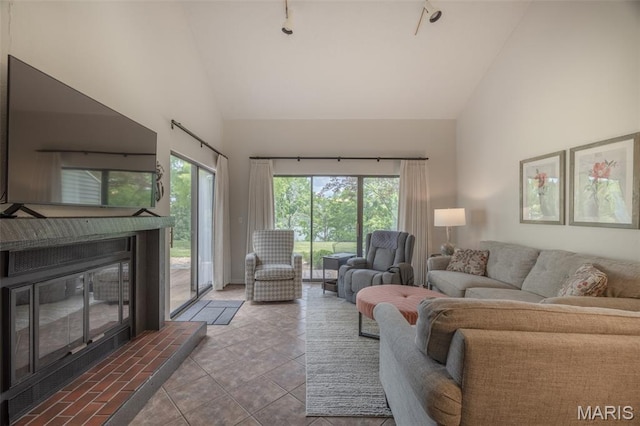 15 Lionshead Ridge Dr Unit 15, Innsbrook, MO 63390 - living area with high vaulted ceiling, a tile fireplace, and tile patterned flooring