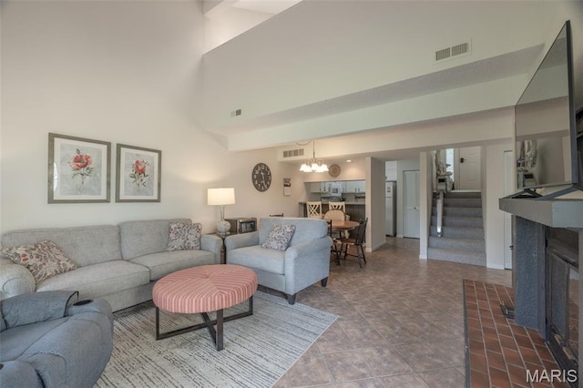 15 Lionshead Ridge Dr Unit 15, Innsbrook, MO 63390 - living room with a high ceiling, stairs, and a chandelier