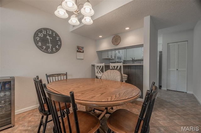15 Lionshead Ridge Dr Unit 15, Innsbrook, MO 63390 - tiled dining room with a chandelier, a textured ceiling, and beverage cooler