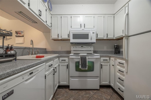 15 Lionshead Ridge Dr Unit 15, Innsbrook, MO 63390 - kitchen with white appliances, dark tile patterned flooring, and white cabinets
