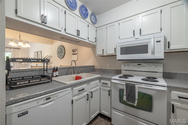 15 Lionshead Ridge Dr Unit 15, Innsbrook, MO 63390 - kitchen with white appliances, a chandelier, white cabinets, dark tile patterned floors, and a textured ceiling
