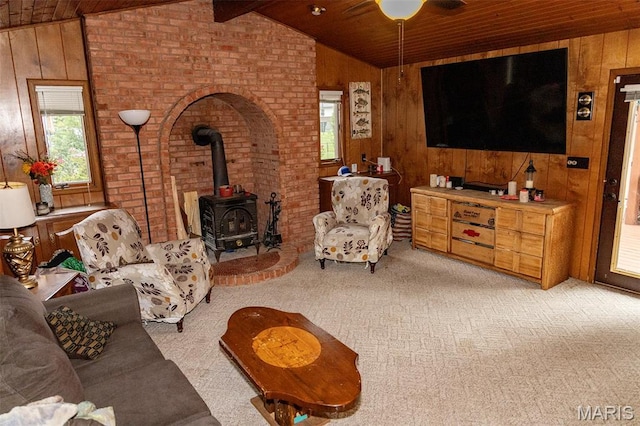 49 Bedford Dr, Belleville, IL 62226 - living room with wood ceiling, a wood stove, wood walls, and light carpet