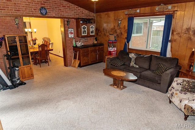 49 Bedford Dr, Belleville, IL 62226 - carpeted living room featuring brick wall, a chandelier, lofted ceiling, and wood walls