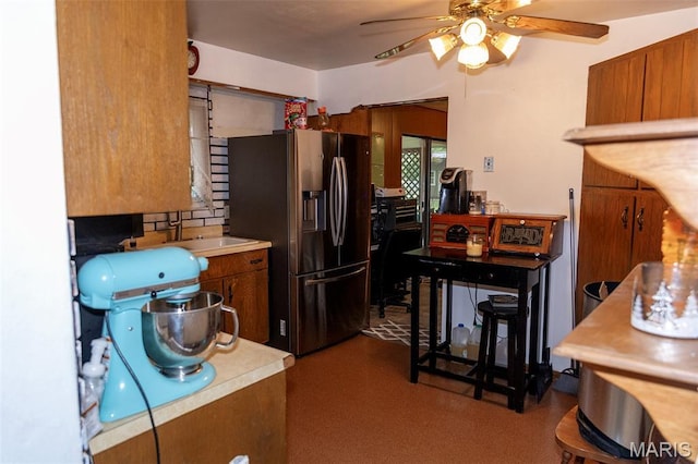 49 Bedford Dr, Belleville, IL 62226 - kitchen with stainless steel fridge with ice dispenser, ceiling fan, brown cabinetry, and light countertops