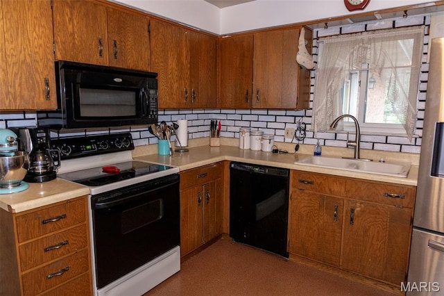 49 Bedford Dr, Belleville, IL 62226 - kitchen featuring black appliances, backsplash, light countertops, and brown cabinetry
