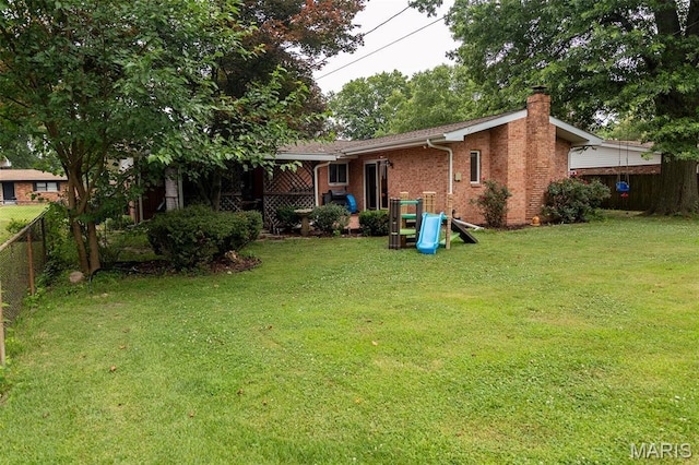 49 Bedford Dr, Belleville, IL 62226 - back of house with a chimney, brick siding, and a playground