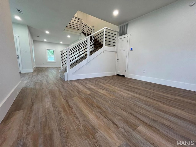 302 State St, Scott City, MO 63780 - unfurnished living room with stairs, wood finished floors, and recessed lighting