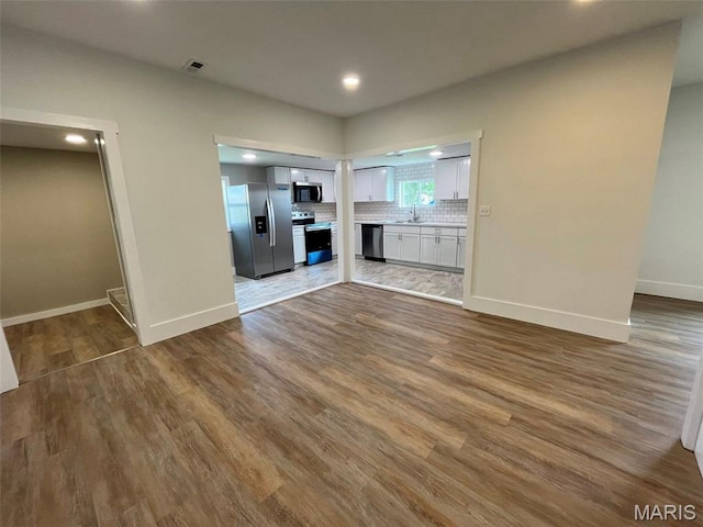 302 State St, Scott City, MO 63780 - unfurnished living room featuring wood finished floors and recessed lighting