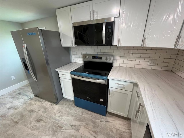 302 State St, Scott City, MO 63780 - kitchen with stainless steel appliances, backsplash, white cabinetry, and light stone countertops