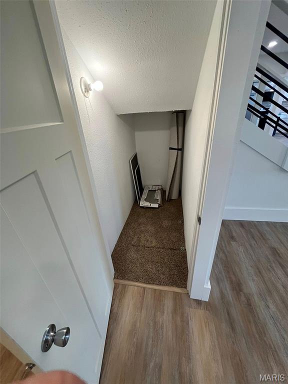 302 State St, Scott City, MO 63780 - staircase with wood finished floors and a textured ceiling
