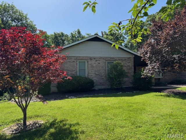 7 Forest Hills Dr, Washington, MO 63090 - view of home's exterior featuring a yard and brick siding