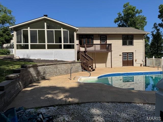 7 Forest Hills Dr, Washington, MO 63090 - back of property with stairway, a sunroom, and a patio area