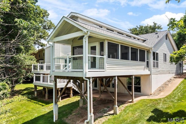510 Wetherby Terrace Dr, Ballwin, MO 63021 - back of house with a sunroom, a shingled roof, a lawn, and a wooden deck