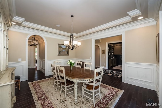 21 Lynnbrook Rd, Saint Louis, MO 63131 - dining room with arched walkways, a chandelier, dark wood-style flooring, crown molding, and wainscoting