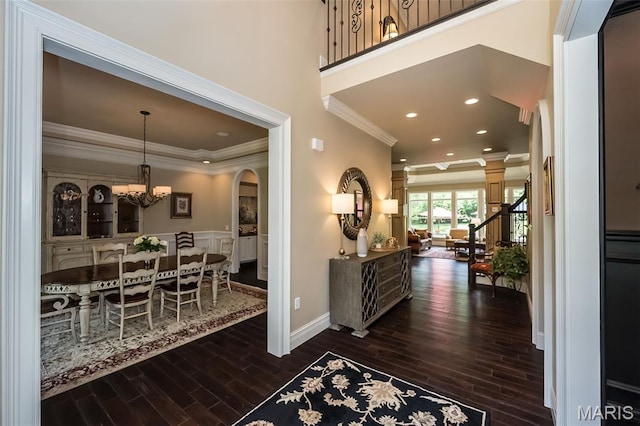 21 Lynnbrook Rd, Saint Louis, MO 63131 - foyer entrance with dark wood-type flooring, crown molding, arched walkways, a chandelier, and recessed lighting
