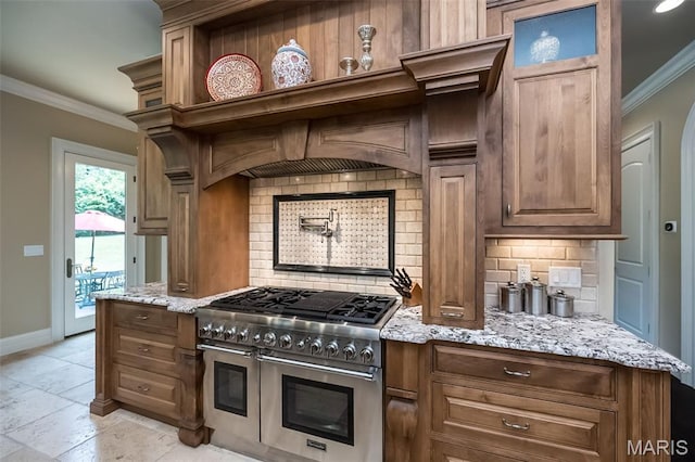 21 Lynnbrook Rd, Saint Louis, MO 63131 - kitchen featuring range with two ovens, crown molding, decorative backsplash, light stone counters, and stone tile flooring