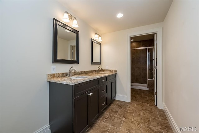 21 Lynnbrook Rd, Saint Louis, MO 63131 - full bath featuring double vanity, a stall shower, stone finish floors, and recessed lighting