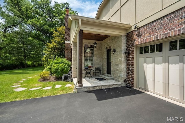 21 Lynnbrook Rd, Saint Louis, MO 63131 - view of exterior entry featuring a lawn, stone siding, driveway, a chimney, and a garage