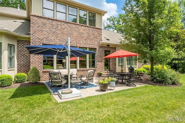 21 Lynnbrook Rd, Saint Louis, MO 63131 - rear view of property with brick siding, a patio, a yard, and a shingled roof