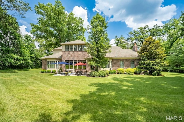 21 Lynnbrook Rd, Saint Louis, MO 63131 - back of house featuring a patio area, brick siding, a yard, and a chimney