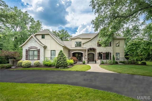 21 Lynnbrook Rd, Saint Louis, MO 63131 - french country inspired facade featuring stone siding, stucco siding, and a front yard