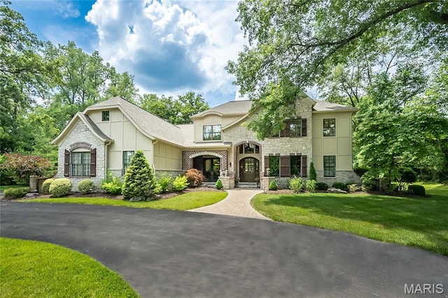21 Lynnbrook Rd, Saint Louis, MO 63131 - french country home featuring stone siding and a front yard