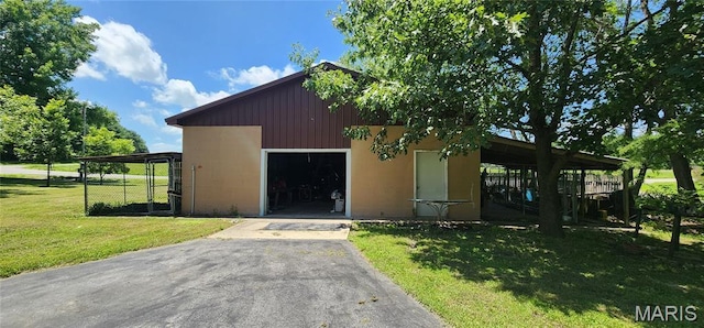 8739 Shawneetown Trl, Chester, IL 62233 - view of front of property featuring a front lawn, asphalt driveway, and an outdoor structure
