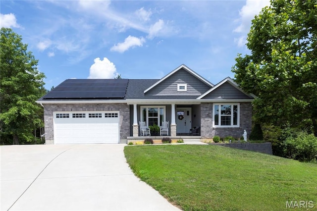 358 N Thomas St, De Soto, MO 63020 - craftsman-style house with a porch, driveway, an attached garage, solar panels, and a front lawn
