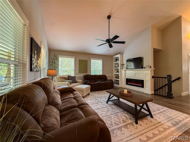 358 N Thomas St, De Soto, MO 63020 - living room with ceiling fan, wood finished floors, a glass covered fireplace, and high vaulted ceiling