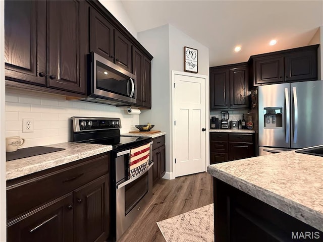 358 N Thomas St, De Soto, MO 63020 - kitchen featuring stainless steel appliances, light countertops, backsplash, and recessed lighting