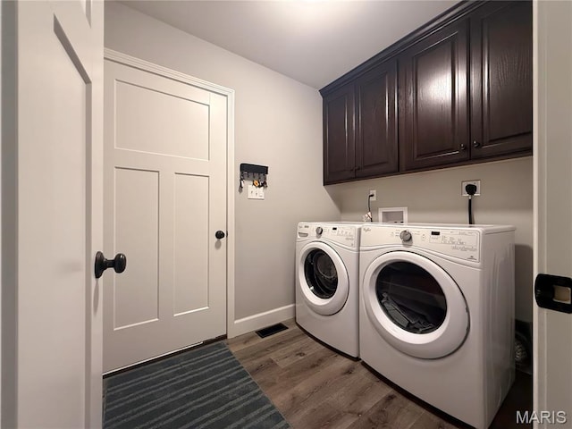 358 N Thomas St, De Soto, MO 63020 - laundry area with cabinet space, washing machine and clothes dryer, and wood finished floors