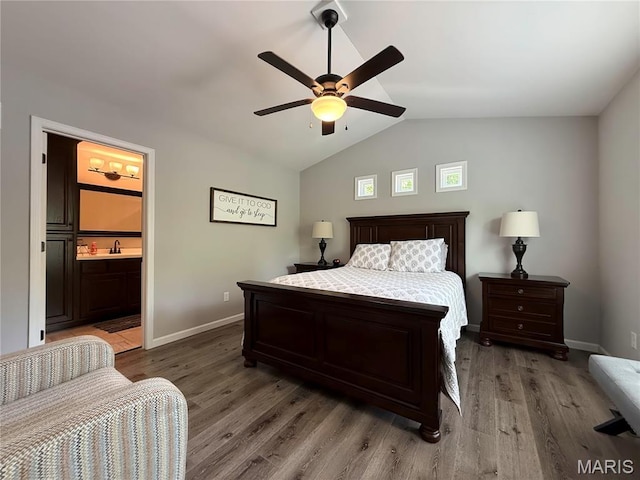 358 N Thomas St, De Soto, MO 63020 - bedroom featuring vaulted ceiling, wood finished floors, a ceiling fan, and ensuite bath