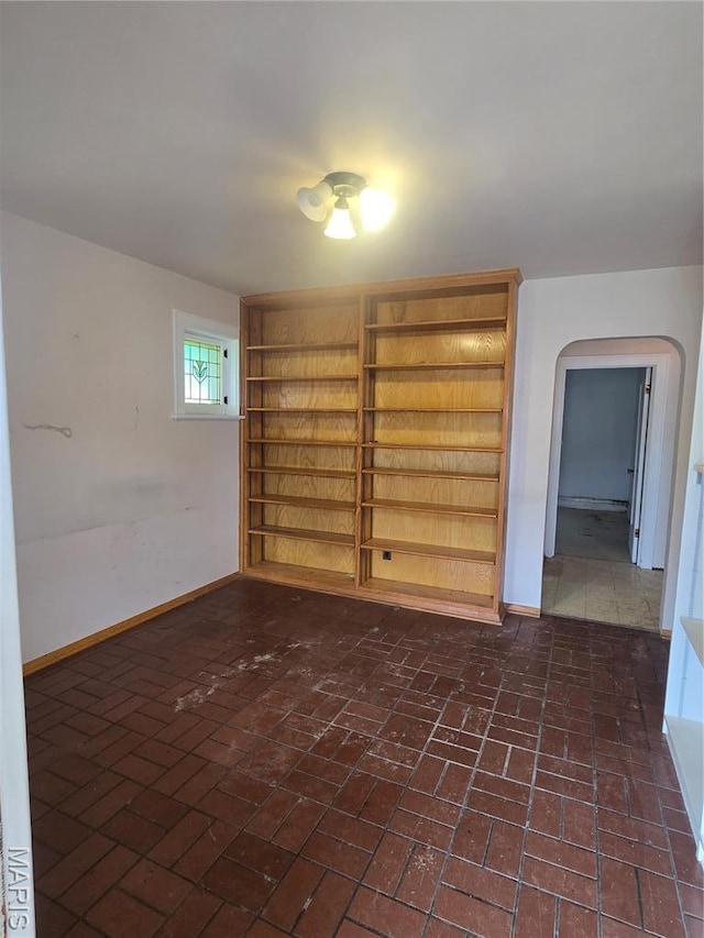 5425 Sunshine, Saint Louis, MO 63109 - empty room with arched walkways and brick flooring