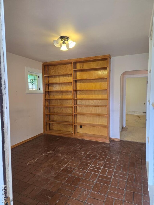 5425 Sunshine, Saint Louis, MO 63109 - spare room featuring brick flooring and arched walkways