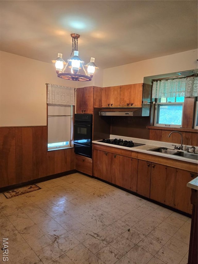 5425 Sunshine, Saint Louis, MO 63109 - kitchen with black appliances, brown cabinetry, a warming drawer, light flooring, and a wainscoted wall