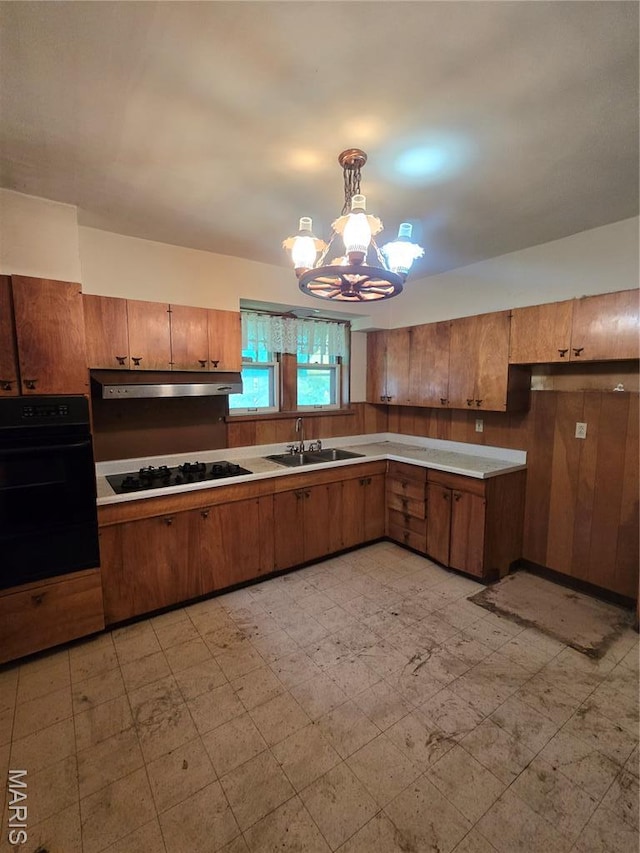 5425 Sunshine, Saint Louis, MO 63109 - kitchen with black appliances, a chandelier, light flooring, and brown cabinets