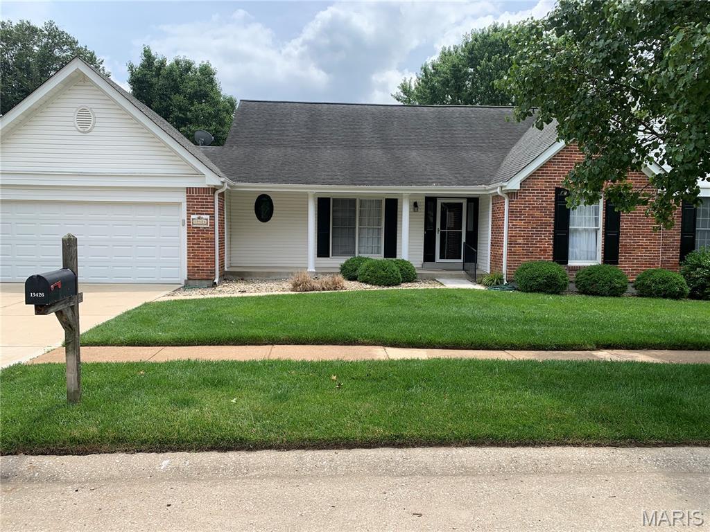 13426 Bahnfyre Dr, Tesson Ferry Township, MO 63128 - view of front of home featuring brick siding, an attached garage, driveway, and a front yard