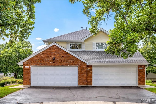 1905 King Arthur Ct, Maryland Heights Township, MO 63146 - traditional-style home with a garage, roof with shingles, and brick siding