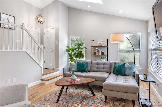1905 King Arthur Ct, Maryland Heights Township, MO 63146 - living area featuring wood finished floors, plenty of natural light, high vaulted ceiling, recessed lighting, and a chandelier