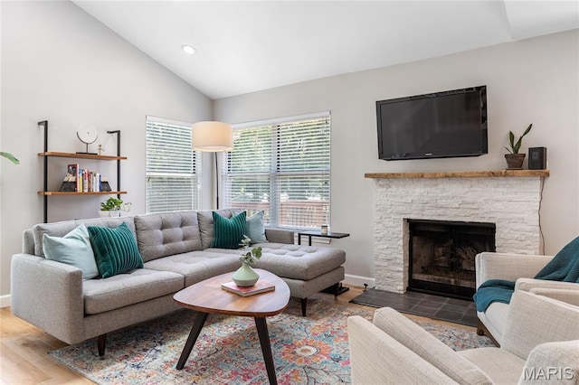 1905 King Arthur Ct, Maryland Heights Township, MO 63146 - living area featuring wood finished floors, lofted ceiling, recessed lighting, and a stone fireplace