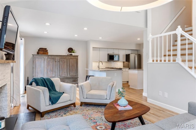 1905 King Arthur Ct, Maryland Heights Township, MO 63146 - living room with light wood finished floors, stairway, recessed lighting, and a fireplace